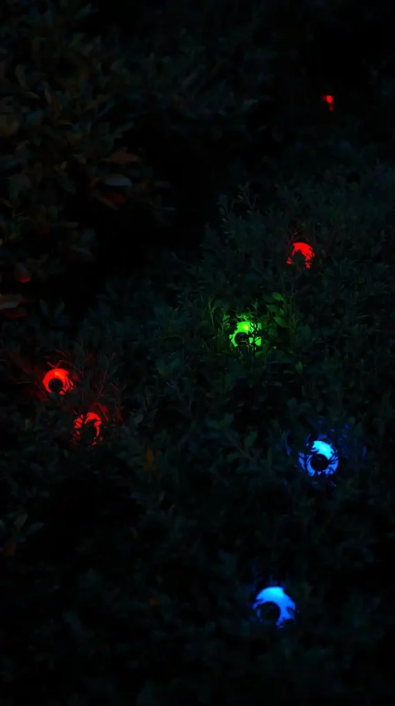 27 Best Halloween Home Decor Outdoor DIY Ideas for 2025 27 Glowing Eyeballs in the Bushes
