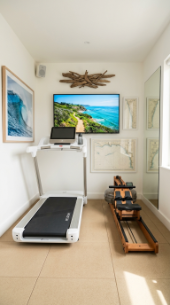 18 Coastal Home Gym Inspiration Garage Conversion Ideas 11 11. Coastal Cardio Room With Treadmill and Ocean View TV Wall