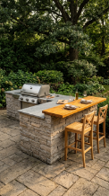 18 Easy Outdoor Kitchen DIY Ideas Modern L-Shape Build 12 12. Stacked Stone Veneer L-Shape With Warm Wood Counter and Built-In Grill