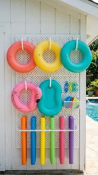 18 Chic Pool Float Storage Ideas for a Tidy Pool 5 5. Install a Pegboard Float Organizer on the Pool House Wall