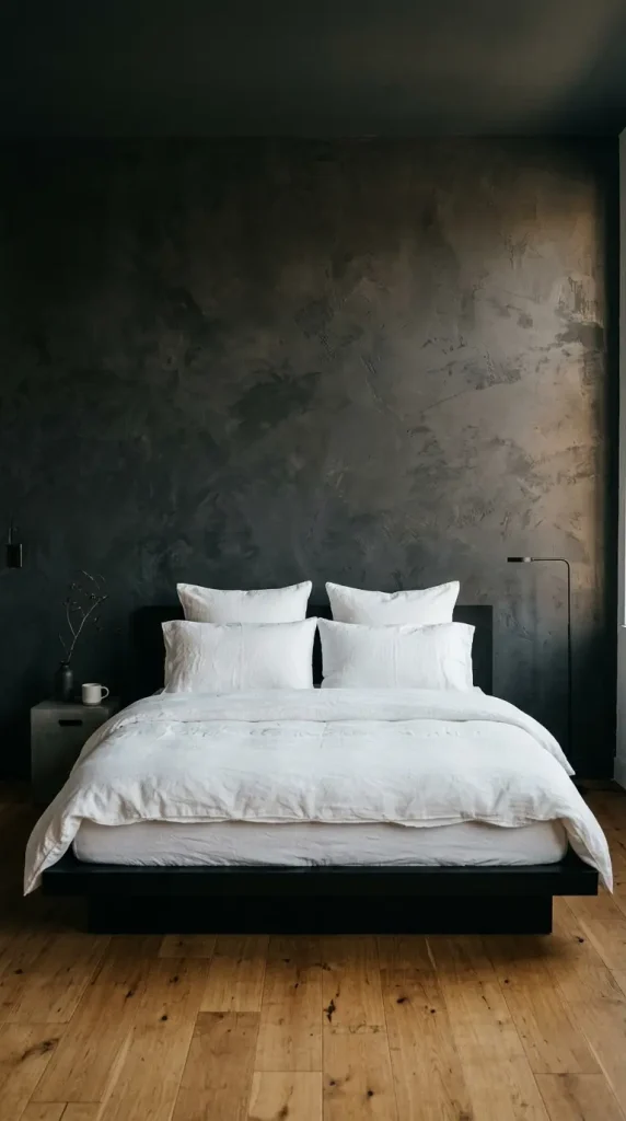 13 Minimalist Luxury Bedroom Dark Moody Charcoal Dramatic Calm 1 1. Charcoal Limewash Wall Behind an All White Linen Bed
