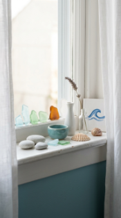 17 Bedroom Aesthetic Coastal Grandmother Sea Glass Blue 10 10. Sea Glass Vessels and Collected Objects on the Windowsill