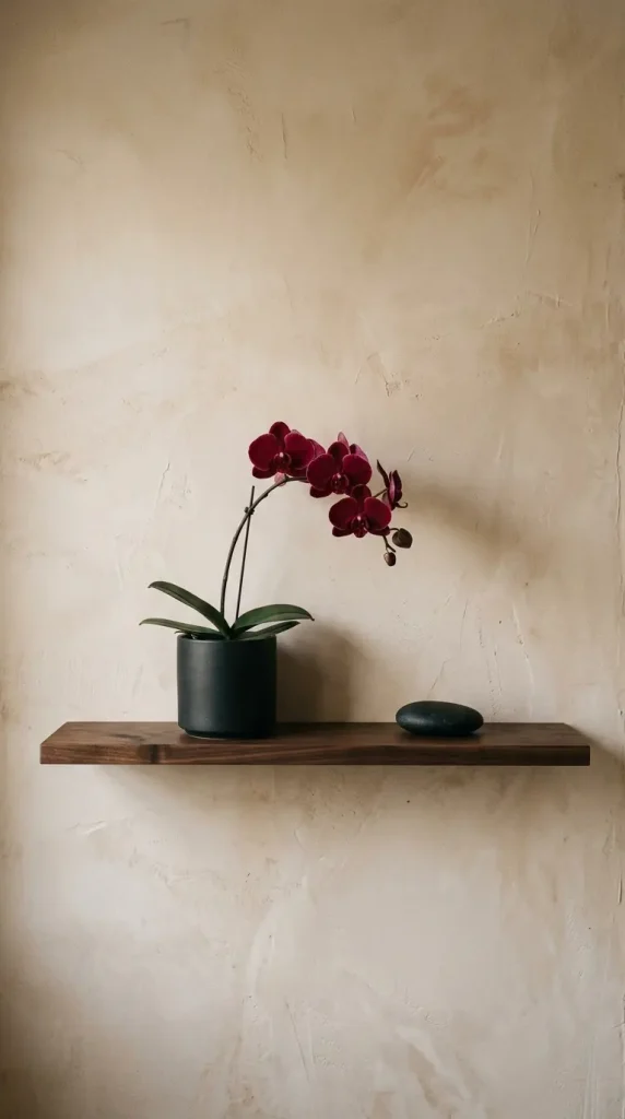 26 Bathroom Shelf Plants Decor Japandi Orchid Minimal 11 11. Dark Shelf with Orchid and Single Smooth Stone — Maximum Restraint