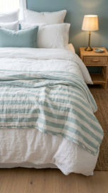 17 Bedroom Aesthetic Coastal Grandmother Sea Glass Blue 14 14. A Stripe Pattern Cotton Quilt as a Layering Piece