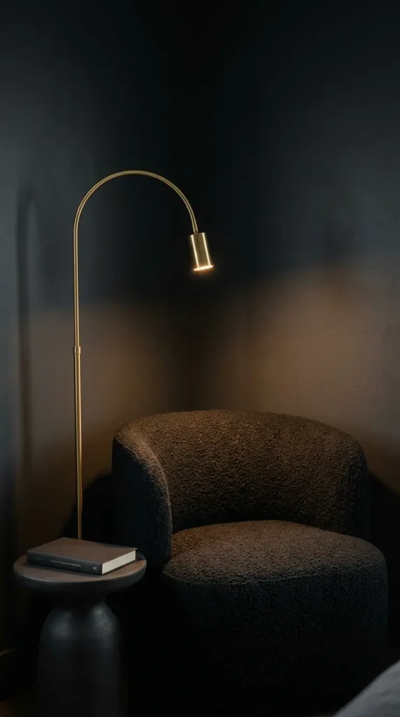 13 Minimalist Luxury Bedroom Dark Moody Charcoal Dramatic Calm 7 7. Moody Bedroom Corner With a Dark Boucle Chair