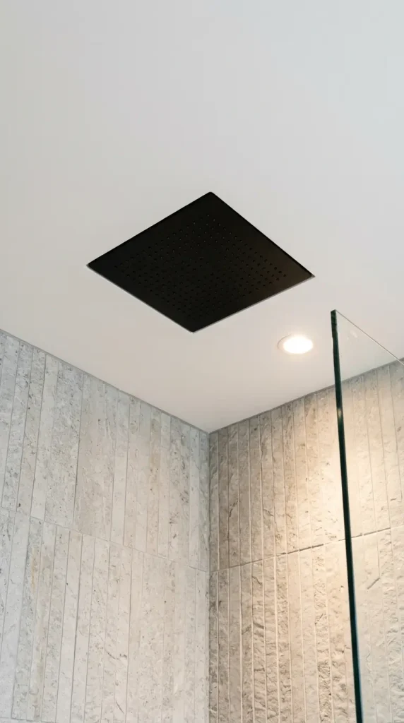 16 Laundry Room Bathroom Combo Maximized Built-In Minimal 11 11. A Ceiling-Mounted Rain Shower Head Recessed Into the Ceiling