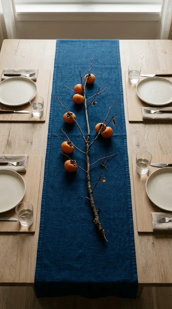 13 Blue and Orange Thanksgiving Table Ideas to Save 2 2. Japandi Indigo Linen and a Single Persimmon Branch