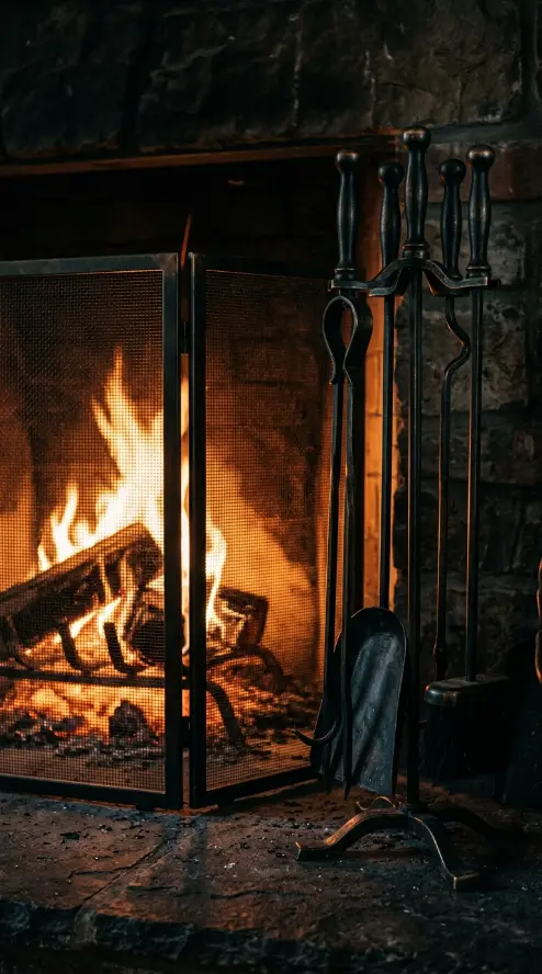 11 Cozy Reading Corners Fireplace Green Sofa Cinematic 4 4. Blackened Brass Fireplace Tools and Screen