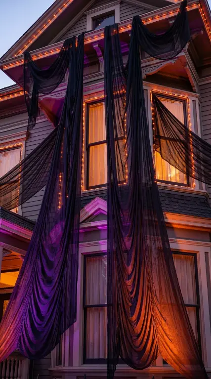 12 Outdoor Halloween Display Haunted House Front Yard 7 7. Black Gauze From the Roofline and Upper Windows